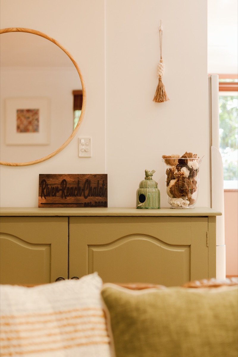 Hand-painted River Reach Chalet sign on the sideboard