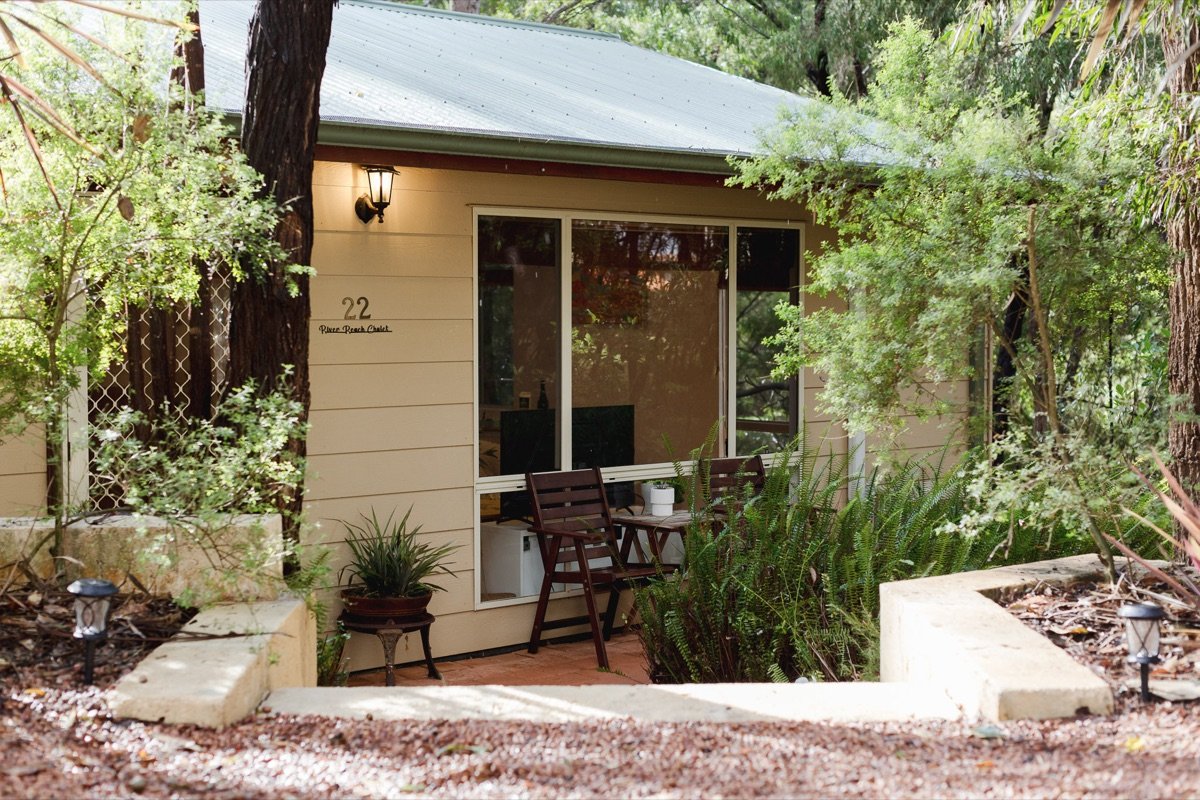 Front of River Reach Chalet with verandah and native garden