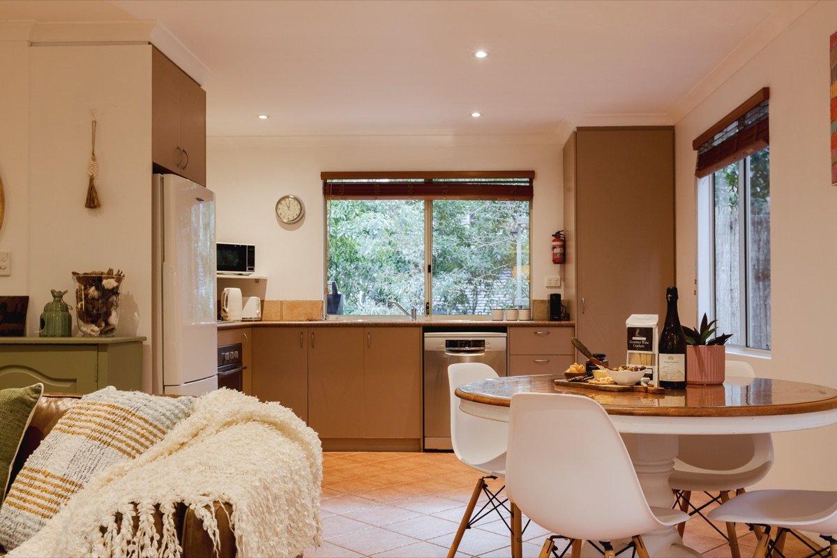 Dining area and kitchen with forest views at the chalet